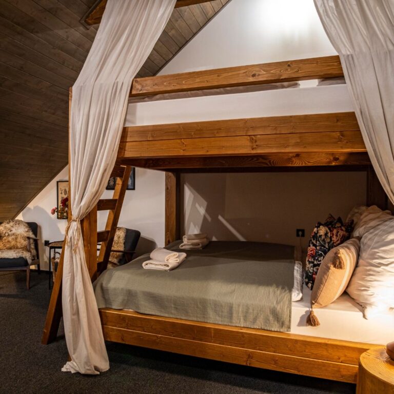 Room with a double bunk bed and a kitchenette